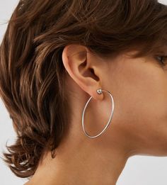 The Icon Hoops are re-engineered to be more functional and elevated than ever. Consider these your wear-with-everything piece; a classic hoop shape that never goes out of style. The 360 degree full circle design means the earrings won't catch your hair. The flexible stainless steel material is water-durable and one third of an inch thicker than the previous design. An easy-to-use tension closure to ensure the Icon Hoops will stay put and you won't have to search for an earring backing. Finished in high-polish rhodium. inish: high polishrhodium ion plated steeltension closure product measurements:length: 57mm / 2.24"width: 55mm / 2.17"depth: 6.8mm / 0.27"wire thickness: 2mm / 0.08"weight: 3.25g / 0.113oz Bird Icon, Jenny Bird, Media Icon, Virtual Fashion, Bag Icon, Polish Silver, Gold Dipped, Full Circle, Circle Design