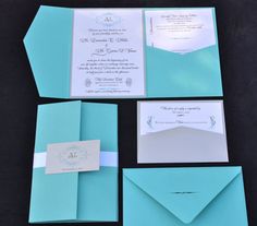 the wedding stationery is laid out on top of each other, with matching envelopes