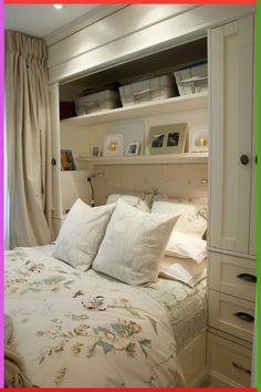 there is a bed with white sheets and pillows in the room that has shelves above it