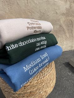 four towels stacked on top of each other in front of a stone wall with the words'little chocolate factory'printed on them