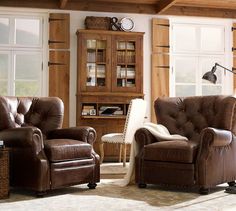 a living room with two chairs and a book shelf