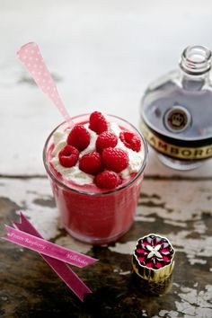 raspberry mousse in a glass with whipped cream and fresh raspberries