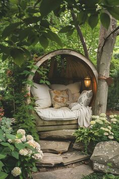 a bed sitting in the middle of a lush green forest filled with flowers and trees