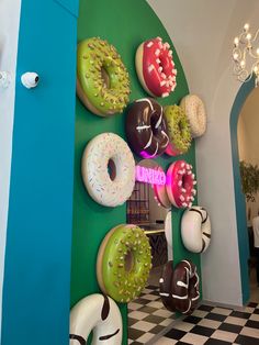 there are many doughnuts on the wall in this room and one is decorated with sprinkles