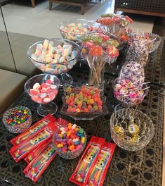 a table topped with lots of candy and candies on top of it's sides