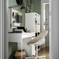 a white desk with a laptop on top of it next to a chair and lamp