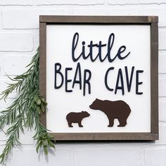 a sign that says little bear cave with an image of a bear and her cub