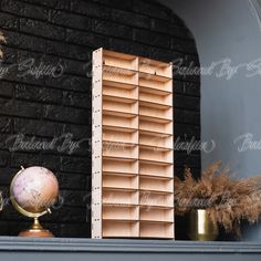 a wooden book shelf sitting next to a brick wall