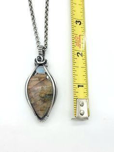 Sometimes less is more... this rose cut labradorite shows flashes of pinkish orange, yellow/gold and a hint of purple... rainbow moonstone shows some light green and blue flashes. Made with oxidize and polished sterling silver... comes with the chain seen in photos (20 inches). Please see all photos as they are considered part of the description Unique Moonstone Healing Jewelry, Unique Moonstone Jewelry For Healing, Artisan Teardrop Moonstone Jewelry, Handmade Sunstone Jewelry For Healing, Labradorite Stones Jewelry For Jewelry Making, Unique Moonstone Jewelry With Stones, Spiritual Jewelry With Natural Sunstone, Nature-inspired Labradorite Jewelry With Natural Stones, Unique One-of-a-kind Moonstone Jewelry