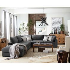 a living room filled with lots of furniture next to a tall clock mounted on the wall