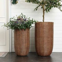 two wicker planters with plants in them