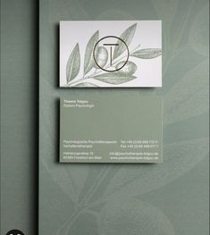 the business card is designed to look like an olive tree branch with leaves on it