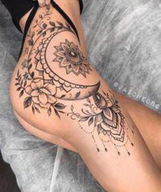 a woman's legs with tattoos on them and flowers in the middle of her leg