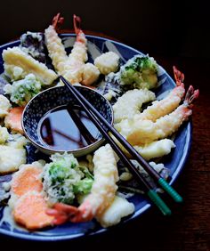 a plate full of food with chopsticks on it