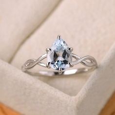 a ring with an aqua blue topazte in it