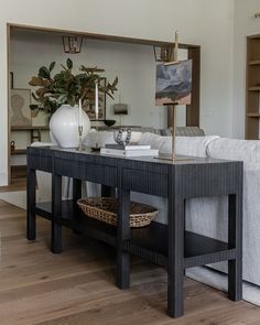 a living room with a couch, coffee table and bookshelf