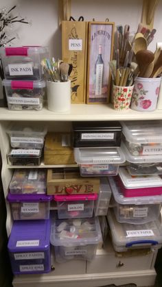 the shelves are filled with plastic containers and craft supplies