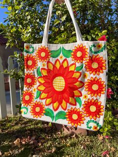 This stunning embroidered flower tote bag is an absolute must-have. Incredible detailing with breathtaking colors that will have everyone complimenting. Beautifully made by Artisans in Mexico.  Large enough to use for shopping, use as a diaper bag, school, beach, and everyday use.  Please advise that each bag is handmade and each design will vary. Some of the designs might have different flower shapes and colors may be slightly different from the image due to picture editing. If you want a speci Rectangular Cotton Bags With Multicolor Embroidery, Embroidered Cotton Tote Canvas Bag For Daily Use, Embroidered Cotton Tote For Daily Use, White Tote Shoulder Bag With Embroidered Logo, Rectangular Canvas Bag With Floral Embroidery For Gifts, Multicolor Embroidered Cotton Tote Shoulder Bag, White Cotton Bag With Floral Embroidery, White Cotton Bags With Floral Embroidery, Rectangular Floral Embroidery Canvas Bag Gift