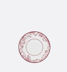 a red and white plate sitting on top of a table