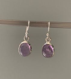 Amethyst oval earrings Silver Oval Earrings For Everyday, Oval Sterling Silver Earrings With Polished Finish, Silver Dainty Earrings With Polished Finish, Dainty Silver Earrings With Polished Finish, Oval Birthstone Earrings In White Gold, Oval White Gold Earrings With Birthstone, Hypoallergenic Oval Earrings For Formal Occasions, Silver Amethyst Gemstone Earrings, Silver Amethyst Earrings With Ear Wire