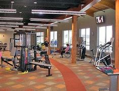 people are in the gym with exercise equipment