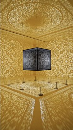 an intricately designed room with two square lights in the center and four poles on each side