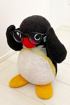 a stuffed penguin with glasses on it's head