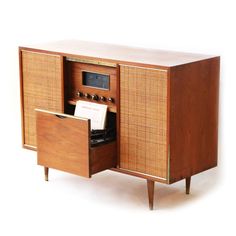 an old fashioned radio cabinet with its doors open