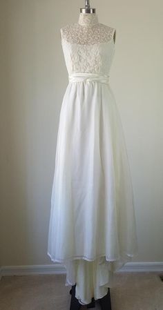 a white dress on a mannequin stand