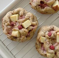 three cookies with apples and cheese on a cooling rack