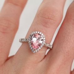 Elegant Vintage Inspired Pink Sapphire Ring ►Made of solid sterling silver with rhodium finish (925) ►Accented With Simulated Diamonds (CZ) ►Average band width: 2 mm Center Stone: Sapphire Color: Pink Shape: Teardrop Gem size: 7.0 x 10.0 mm Carat Weight: 2 ct. (approx.) Gemstone creation: 100% Natural Hardness: 9-9.5 (Mohs scale)- tests like a natural diamond ►Due to the gemstone nature, color of the gem may slightly vary. ✓ 100% Nickel-Free ✓ Hypoallergenic ✓ Comfort Fit ✓ Free Ring Box ✓ Free Anniversary Pear-shaped Halo Jewelry, Pear-shaped Halo Jewelry For Promise Ring, Teardrop Halo Setting Jewelry For Anniversary, Teardrop Center Stone Jewelry For Anniversary, Anniversary Teardrop Center Stone Jewelry, Teardrop Halo Setting Promise Ring, Anniversary Rings With Teardrop Prong Setting, Pear-shaped Halo Setting Jewelry For Promise, Teardrop Halo Ring For Wedding