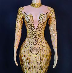 a mannequin with gold sequins on it's body and neck