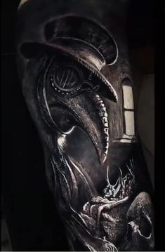 a man's arm with an alien head and window in the middle of it