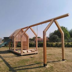 a wooden structure with a swing set in it