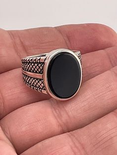 Add a touch of elegance to your outfit with this stunning black onyx ring. Crafted from 925 sterling silver, this ring features a beautiful black onyx stone with a secondary black onyx stone. The ring is available in size 11 and weighs 11.3 grams. Perfect for any occasion, this ring is sure to make a statement. The brand of this ring is BS 925 and the metal purity is 925. The main stone color is black, and the metal is sterling silver 925 Formal Black Onyx Jewelry, Black Onyx Jewelry For Formal Occasions, Black Sterling Silver Signet Ring With Polished Finish, Classic Black Sterling Silver Signet Ring, Classic Black Onyx Jewelry, Classic Black Gemstone Ring, Formal Black Oval Rings, Formal Black Oval Ring, Classic Black Onyx Rings