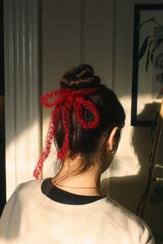 a woman with a red bow in her hair