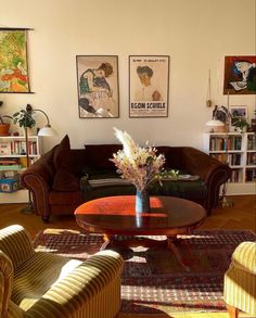 a living room with two couches and a coffee table in front of bookshelves