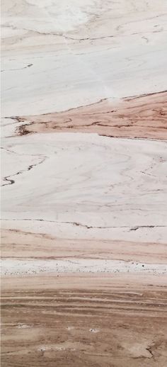 two zebras standing in the middle of an open field with brown and white paint on them