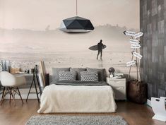 a bedroom with a surfboard hanging from the ceiling and a wall mural behind it