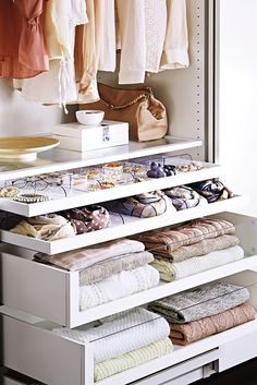 an organized closet with clothes and shoes