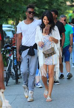 a man and woman walking down the street