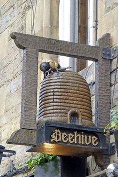 a large bell on the side of a building with a sign that says berhue