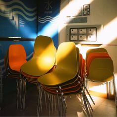 a row of chairs sitting next to each other in front of a water dispenser