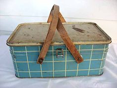 an old blue suitcase with wooden handles