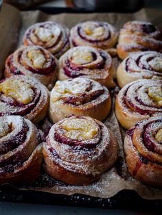 a tray filled with pastries covered in powdered sugar