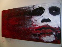 a painting on the wall of a man's face with red and white paint