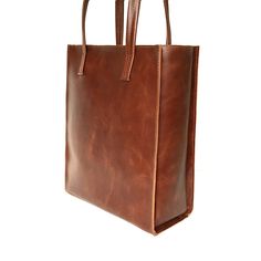 "Tote bag from SHleatnerBags keeps up with the times. The bag has clear lines and holds its shape well. At the same time, the bag is very roomy. Inside the bag there is a pocket with a zipper for small things. Dimensions: Small bag: Height: 11.81\" (30 cm) Width: 9.84\" (25 cm) Depth: 3.15\" (8 cm) Medium bag: Height: 13\" (33 cm) Width: 11.42\" (29 cm) Depth: 3.54\" (9 cm) Large bag: Height: 11.78\" (35 cm) Width: 11.81\" (30 cm) Depth: 5.12\" (13 cm)" Rectangular Box Bag With Leather Handles For Shopping, Leather Square Box Bag For Shopping, Classic Square Box Bag With Leather Handles, Square Business Bags With Leather Handles, Square Leather Box Bag With Top Carry Handle, Leather Box Bag For Shopping, Square Leather Box Bag With Leather Handles, Leather Shoulder Box Bag For Shopping, Modern Cognac Rectangular Shoulder Bag