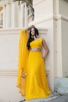 This showstopper mango yellow, Devi, is a must have for your mehendi/haldi ceremony! This colorful and playful mirror lehenga is the perfect party piece. Festive Yellow Pre-draped Saree With Mirror Work, Yellow Mirror Work Sets For Reception, Yellow Pre-draped Saree With Mirror Work For Wedding, Yellow Sets With Mirror Work For Reception, Fitted Yellow Pre-draped Saree With Mirror Work, Yellow Dola Silk Pre-draped Saree For Reception, Yellow Pre-draped Saree With Dori Work For Festivals, Yellow Dresses For Navratri Reception, Yellow Dresses For Reception And Navratri