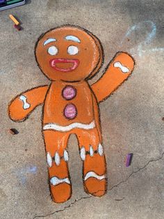 a drawing of a ginger on the ground next to crayons and pencils