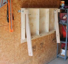 the inside of a garage with shelves and tools hanging on the wall next to it